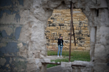 Young tourist girl with backpack visiting Old Joliet Prison, a former abandoned jail