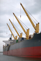 Gdynia, Poland - March 2023: Bulk carrier with unsecured cranes during cargo operations in the European port © I am from Mykolayiv