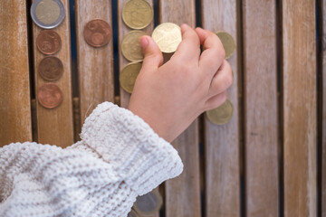 little girl counting euro coins. Tenerife, Canary Islands. Spain