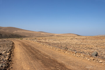 Fototapeta na wymiar Gravel road in a stone desert, Los Molinos, Fuerteventura