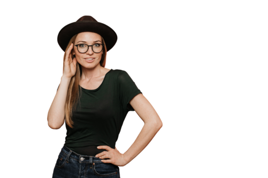Hipster redhead young woman in glasses, casual dark green t-shirt and hat with brim, looks confident, posing over transparent background with copy space. Vogue and shopping concept..