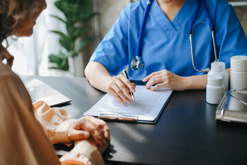 Fototapeta premium Woman doctor consulting with patient discussing something and Presenting results on report, Medicine and health care concept..