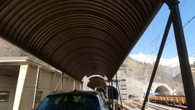 Lotschberg Car Train Approaching Tunnel through Mountain. Switzerland