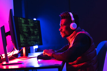 Software developer coding on his computer. Coding and hacking concept..