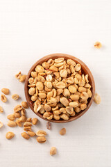 Spicy flavored peanut kernel in a bowl on white table background.