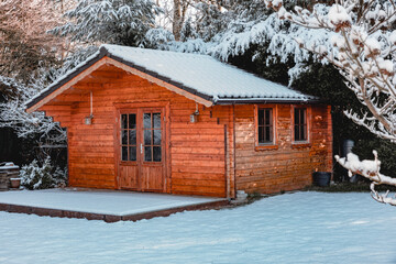 Small wooden house in winter, with snow. Live in small ecological houses, in the forest or in the countryside. garden house