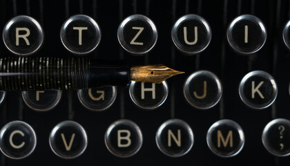 old typewriter with a pen