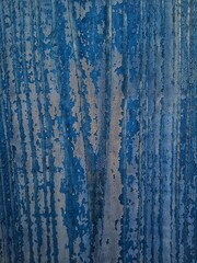 Blue dried paint on a wooden board. blue texture