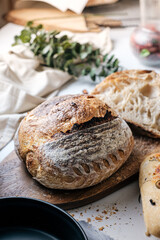 Artisan Batard Sourdough healthy Bread with leaf scoring. Open crumb high hydration Sourdough bread set on white table. - 581414106