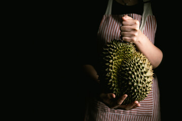 Farmer hand holding Ripe durian the king of tropical fruits. - 581414108