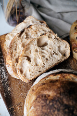 Artisan Batard Sourdough healthy Bread with leaf scoring. Open crumb high hydration Sourdough bread set on white table. - 581414115