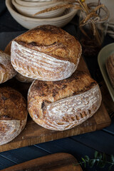 Artisan Batard Sourdough healthy Bread with leaf scoring. Open crumb high hydration Sourdough bread set on white table. - 581414127
