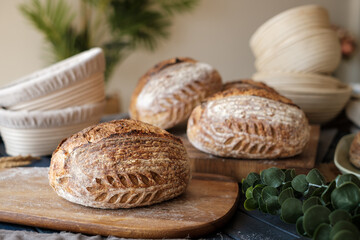 Artisan Batard Sourdough healthy Bread with leaf scoring. Open crumb high hydration Sourdough bread set on white table. - 581414131