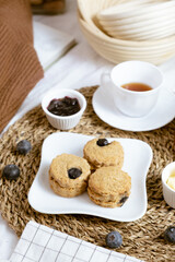 Fototapeta na wymiar Delicious blueberry Scones on white cafe table.