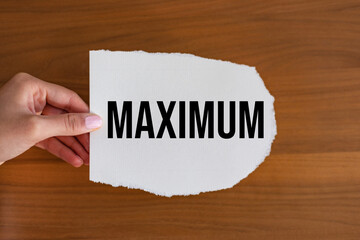 Maximum. Woman hand holds a piece of paper with the note,  maximum. Weight, volume, number,...