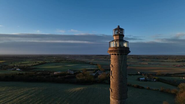 drone shot approaching the spire of lloyd, kells, co meath, ireland