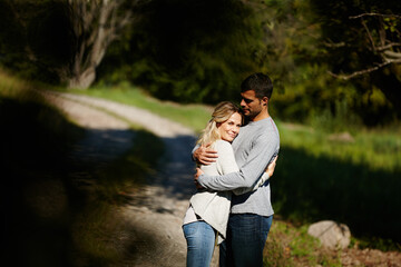 Fototapeta premium Every day is perfect with you. an affectionate young couple hugging in a park.