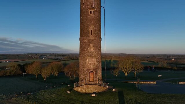 drone shot of spire of lloyd tower in county meath, ireland, at sunrise