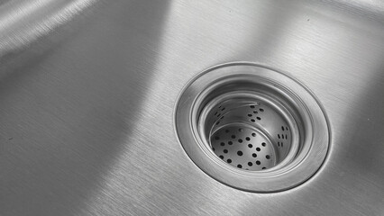 Close-up view of stainless steel sink with drain. 