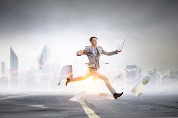 Obraz na płótnie Canvas Portrait of energetic businessman jumping in open air