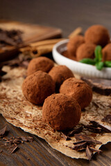 Homemade Chocolate Truffles with Cocoa Powder on Brown Wooden Table.
