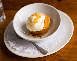 Homemade carrot cake with orange crumbs on plate close-up
