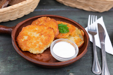Fried grated potato pancakes with sour cream