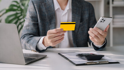 Male businessman use credit cards to conduct financial transactions through smart phone.