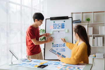Creative digital development agency. developer team brainstorming on their project with laptop, smartphone and digital tablet.