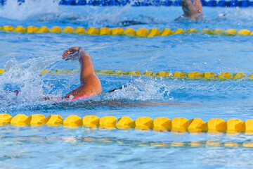 Sport man swimming in the pool at the sport complex.Professional Athlete Training for the Championship.Male Swimmer swimming in swimming pool.