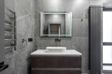 Modern furnished bathroom dark grey interior design with granite tiles