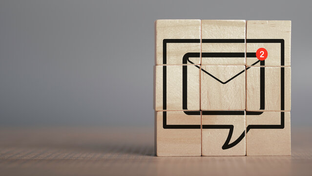 New email notification concept. In box alert and notification icon on wood cubes stack with copy space, Business e-mail communication and digital marketing. Newsletter, online working.