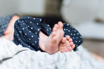 feet in bed with blanket