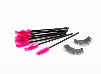 Mascara brushes and false eyelashes isolated on white background. Makeup brushes makeup kits.Disposable brush for eyelashes and eyebrows.Close-up.