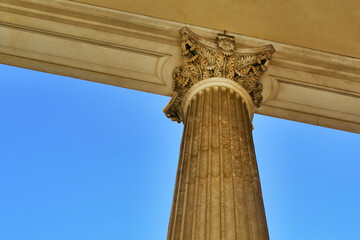 detail from below of ancient marble colonnade in neoclassical style