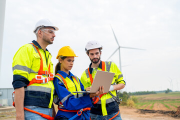 Wind turbine service engineer maintenance and plan for inspection at construction site, renewable electricity generator.