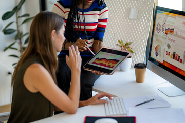Two business woman working in her office.