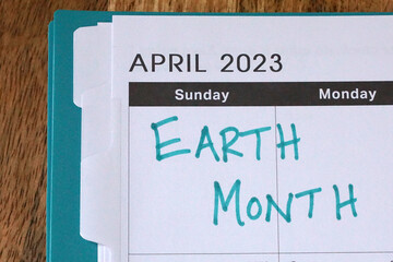 Earth Month written on a calendar for April 2023. It's a time to raise environmental awareness and...