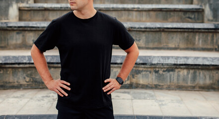 Young guy wearing black blank t-shirt and black cap. Mock-up for print. T-shirt template.