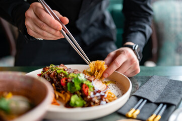 chef hands decorated food on plate