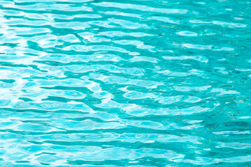 Ripple Water in swimming pool with blue tile floor background