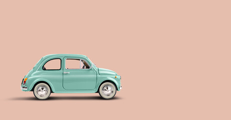 Miniature retro toy car on coral pink background with copyspace - obrazy, fototapety, plakaty