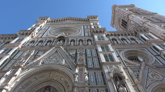 Florence, Italy, seen from below. Details of the cathedral and Giotto's bell tower. View of the Basilica of Santa Maria del Fiore.