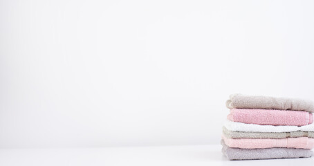 Fototapeta na wymiar set of multicolored bathroom towels isolated on white background. Hygiene . Space for text on the left