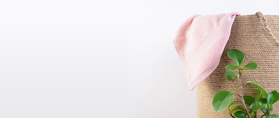 laundry basket wicker twine and towel isolated on white background. Space for text on the left