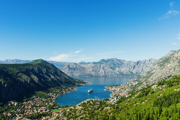 Fototapeta na wymiar Top view of the Bay of Kotor in which there is a huge tourist liner. Postcard view