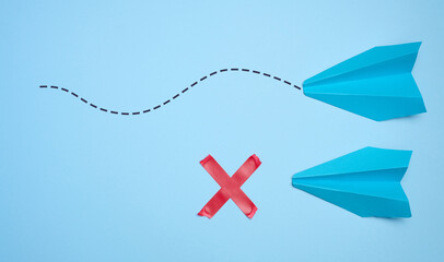 Two paper boats, the path to one of them is stopped. The concept of rejection, obstacles