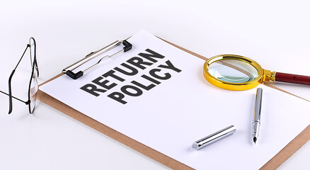 RETURN POLICY text on clipboard on white background, business concept