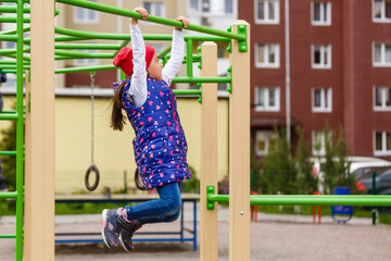 Active little girl on playground.