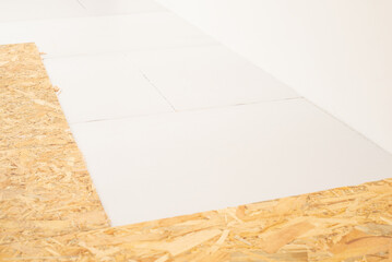 Warming room floor with styrofoam and OSB wood sheets. Glued sheet of styrofoam and OSB on the floor